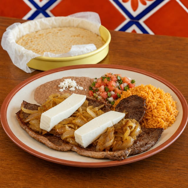 Bistec Encebollado (Steak with Sautéed Onions).