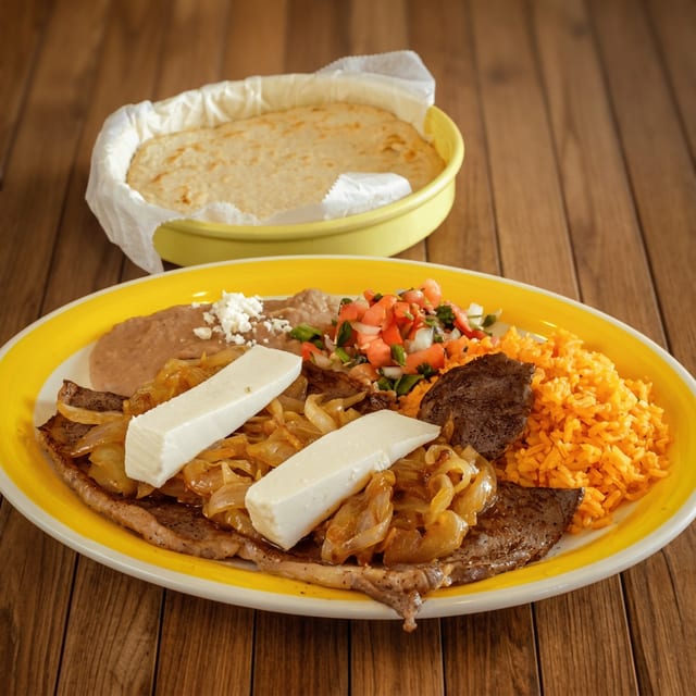 Bistec Encebollado (Steak with Sautéed Onions).