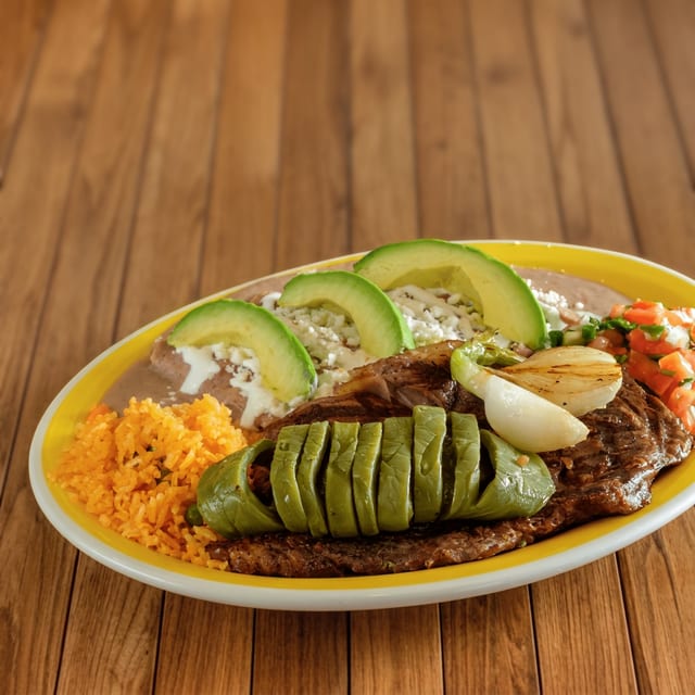 Bistec con Enfrijoladas (Ribeye Steak with Enfrijo).
